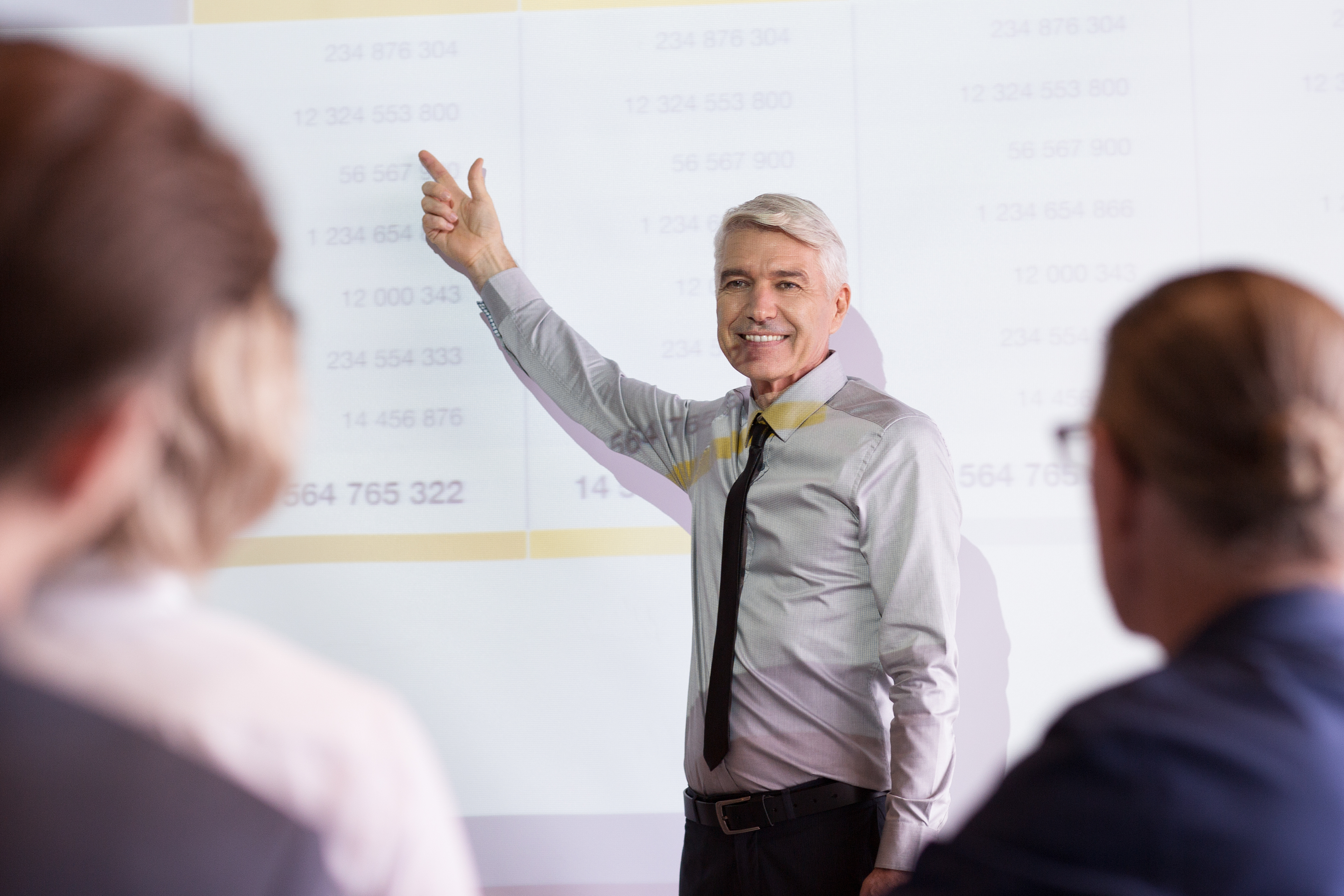 Smiling Senior Lecturer Coaching Business Team